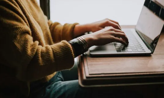 Person completing a health plan enrollment workflow on a laptop