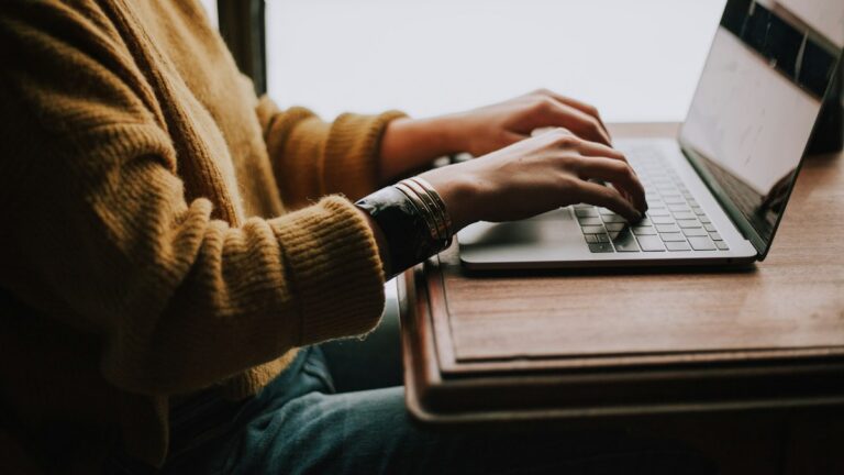Person completing a health plan enrollment workflow on a laptop