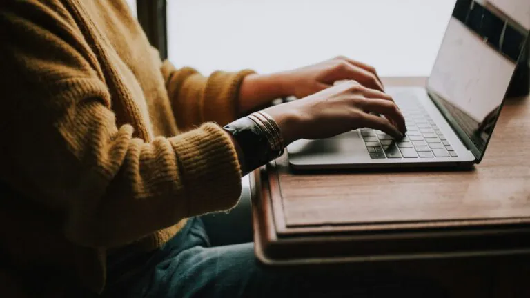 Person completing a health plan enrollment workflow on a laptop