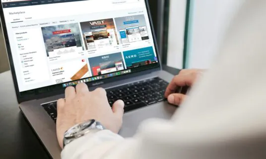Person working in a CRM and quoting workflow on a laptop