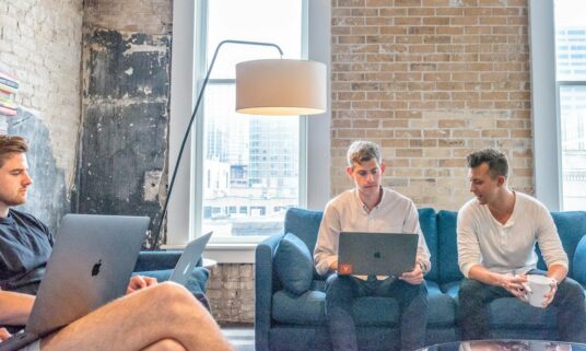 Benefits administration team working together in a modern office