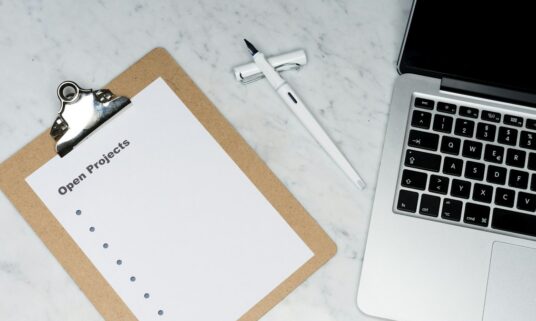Compliance checklist and laptop used for a credentialing standards review