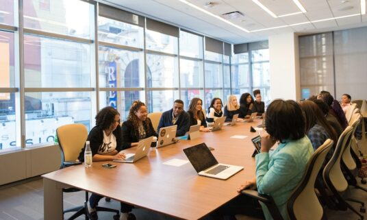 Employees gathered in a meeting room during a benefits enrollment session