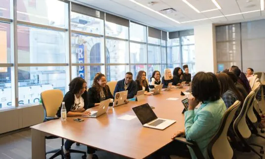 Employees gathered in a meeting room during a benefits enrollment session