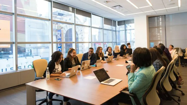 Employees gathered in a meeting room during a benefits enrollment session