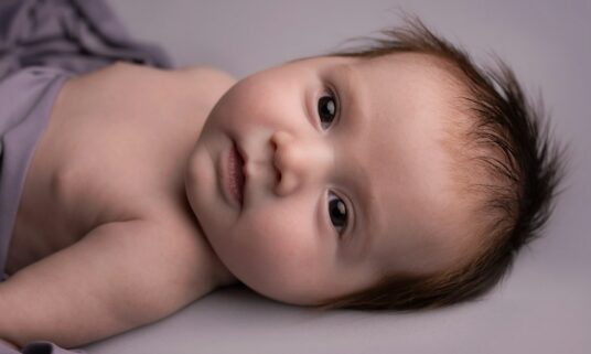 Newborn baby at home, a common qualifying life event for midyear coverage changes