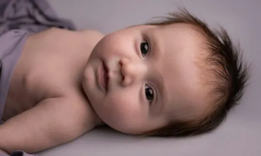 Newborn baby at home, a common qualifying life event for midyear coverage changes
