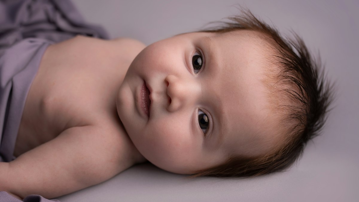 Newborn baby at home, a common qualifying life event for midyear coverage changes